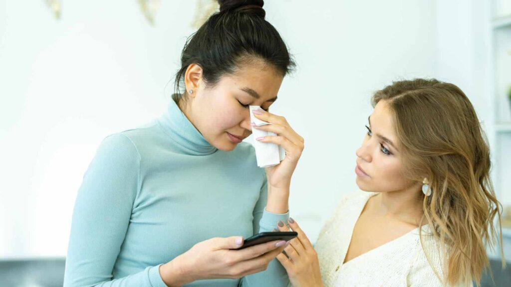 amiga consolando a su amiga ya que su ex la felicitó por navidad